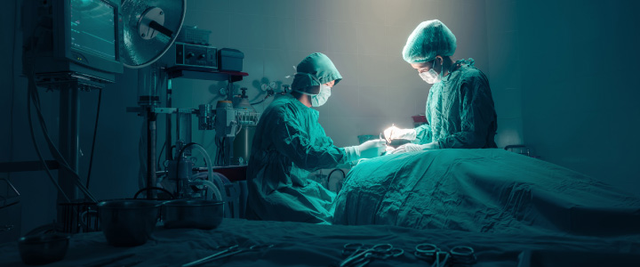 Surgeons team working in surgical operating room.